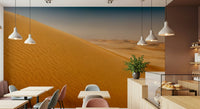 Abstract dunes wallpaper for a bohemian style lounge with indoor plants.