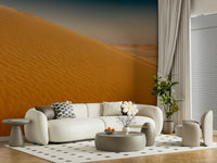 Desert Dune Dreams Wall Mural behind a wooden bed frame in a guest room.