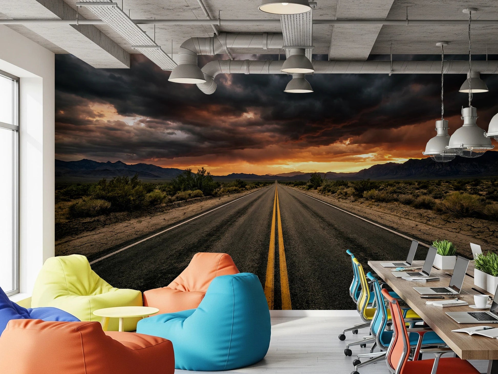 Office area styled with Desert Road wall mural under dark clouds and glowing horizon