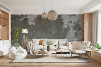 Distressed concrete wallpaper mural behind a sleek sofa.