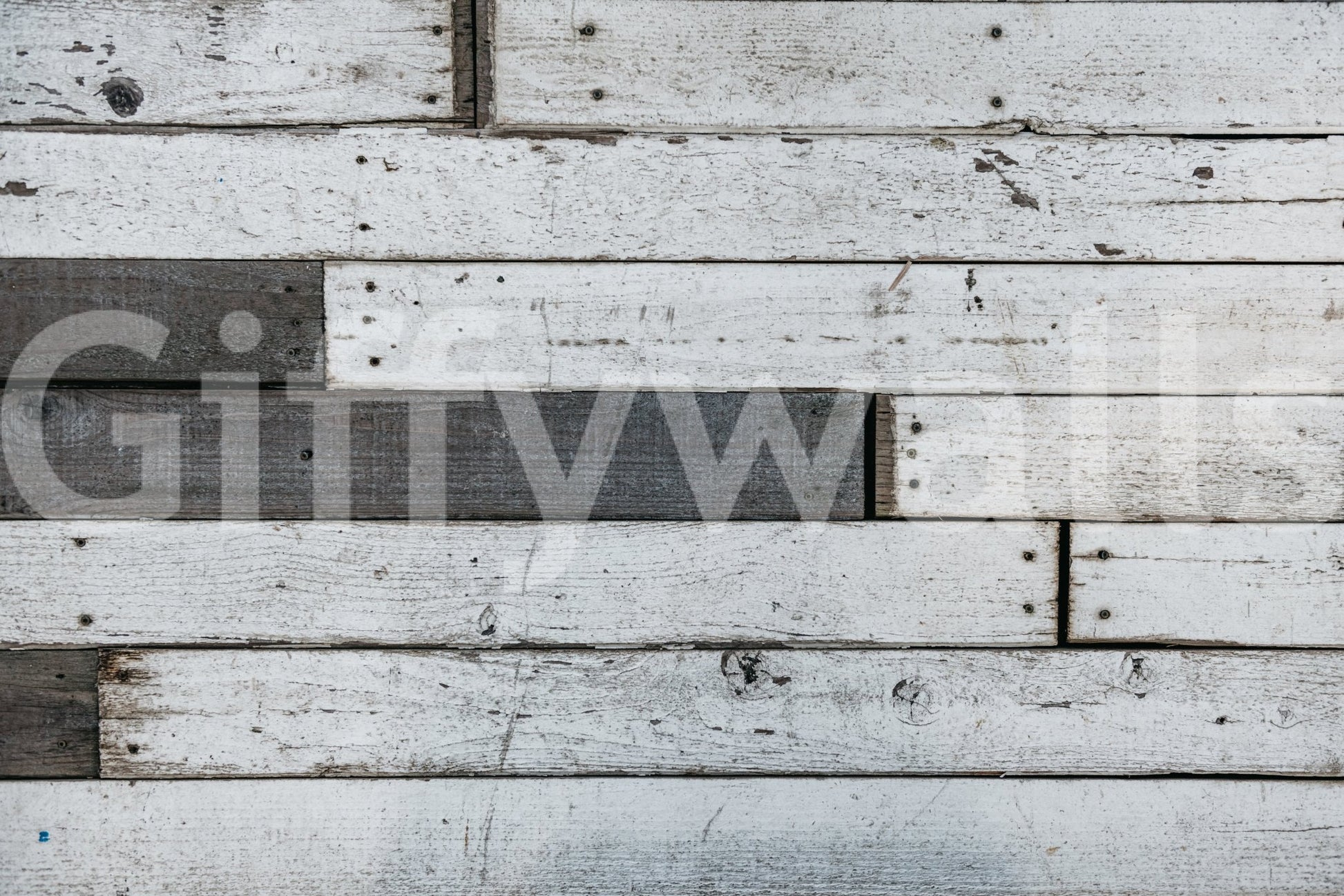 Applying the simple, removable peel and stick wood panel wallpaper.