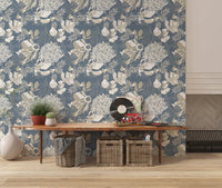 Soft botanical wallpaper with dusty blue ground and detailed flower shapes