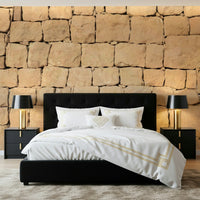 A hand applying the Earthen Wall Texture rustic clay mural.