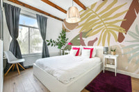 An artistic calming foliage mural on minimalist wallpaper.

