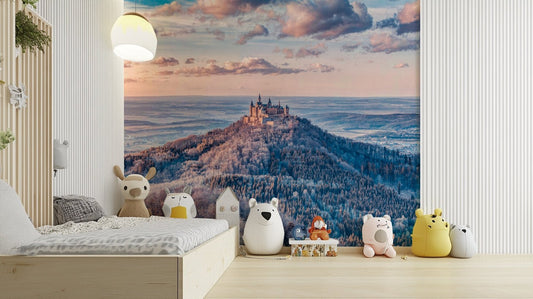A medieval castle sits on a snowy mountaintop.

