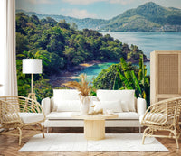 A bright seating room paired with Emerald Coast Wall Mural and lush shoreline detail