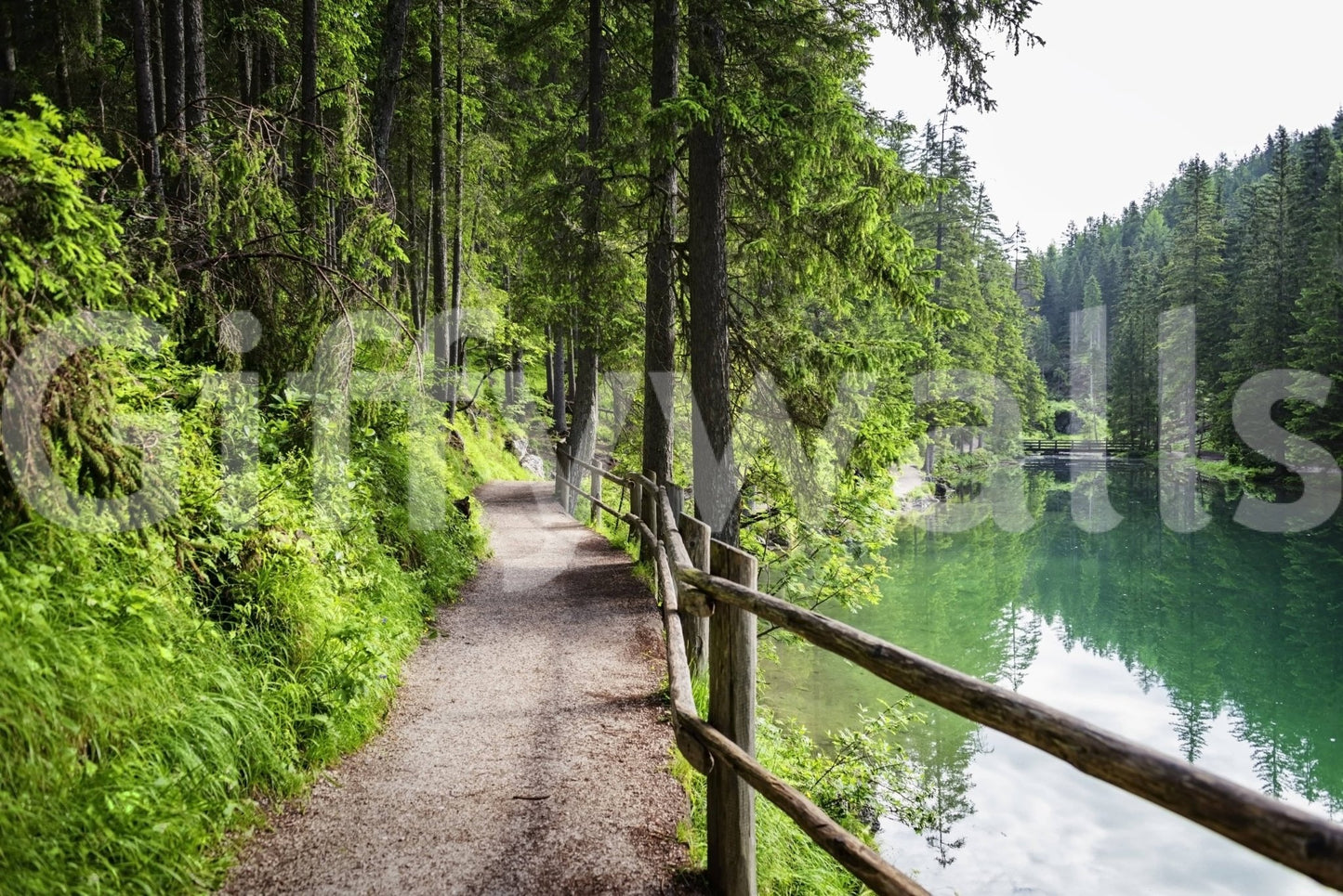 Serene alpine wallpaper featuring emerald green water and granite rocks.