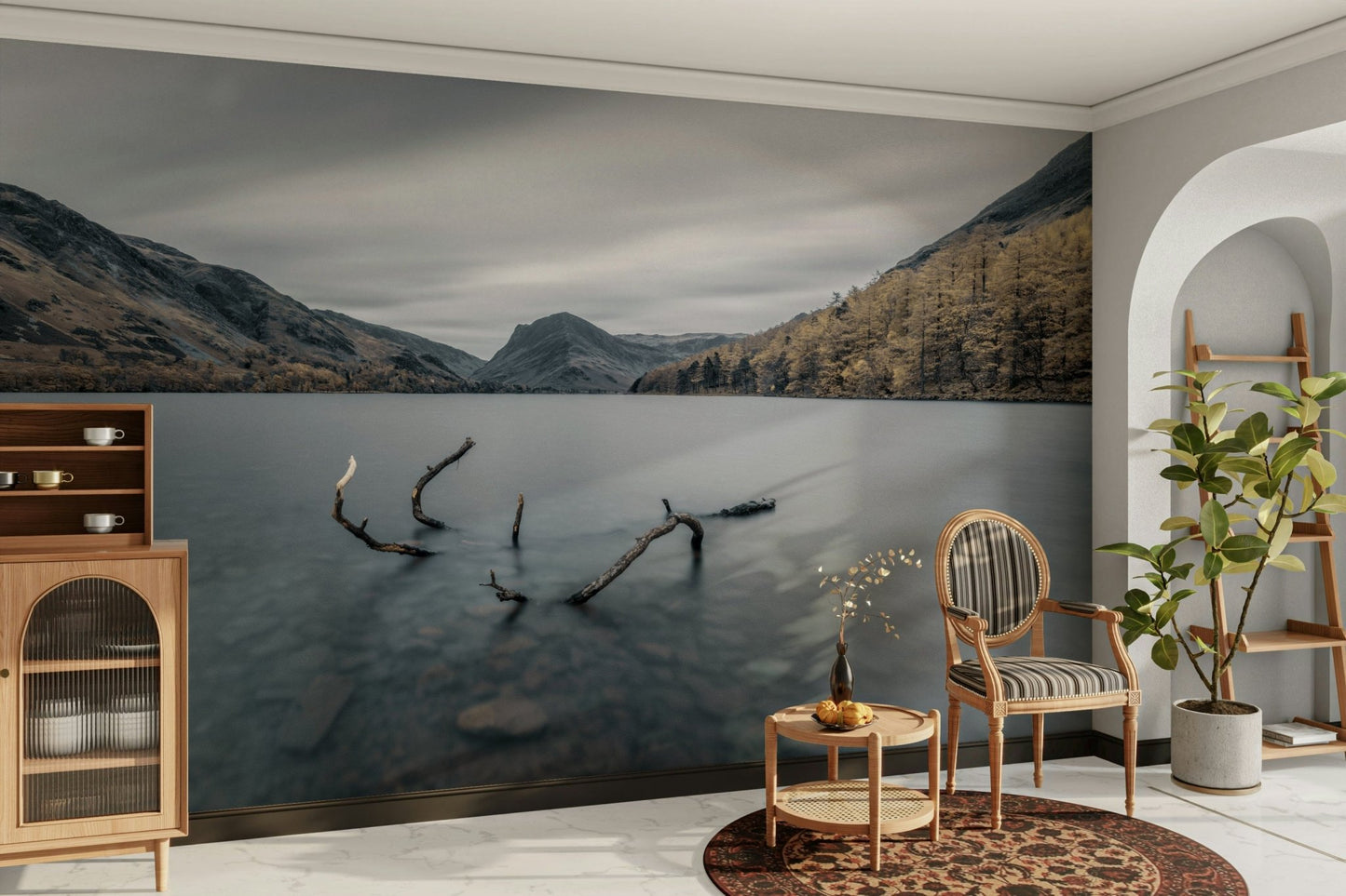 The image shows a peaceful lake surrounded by hills and mountains.

