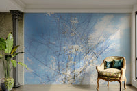 The color palette is composed of soft, muted tones for the flowers and branches, with calming sky hues.