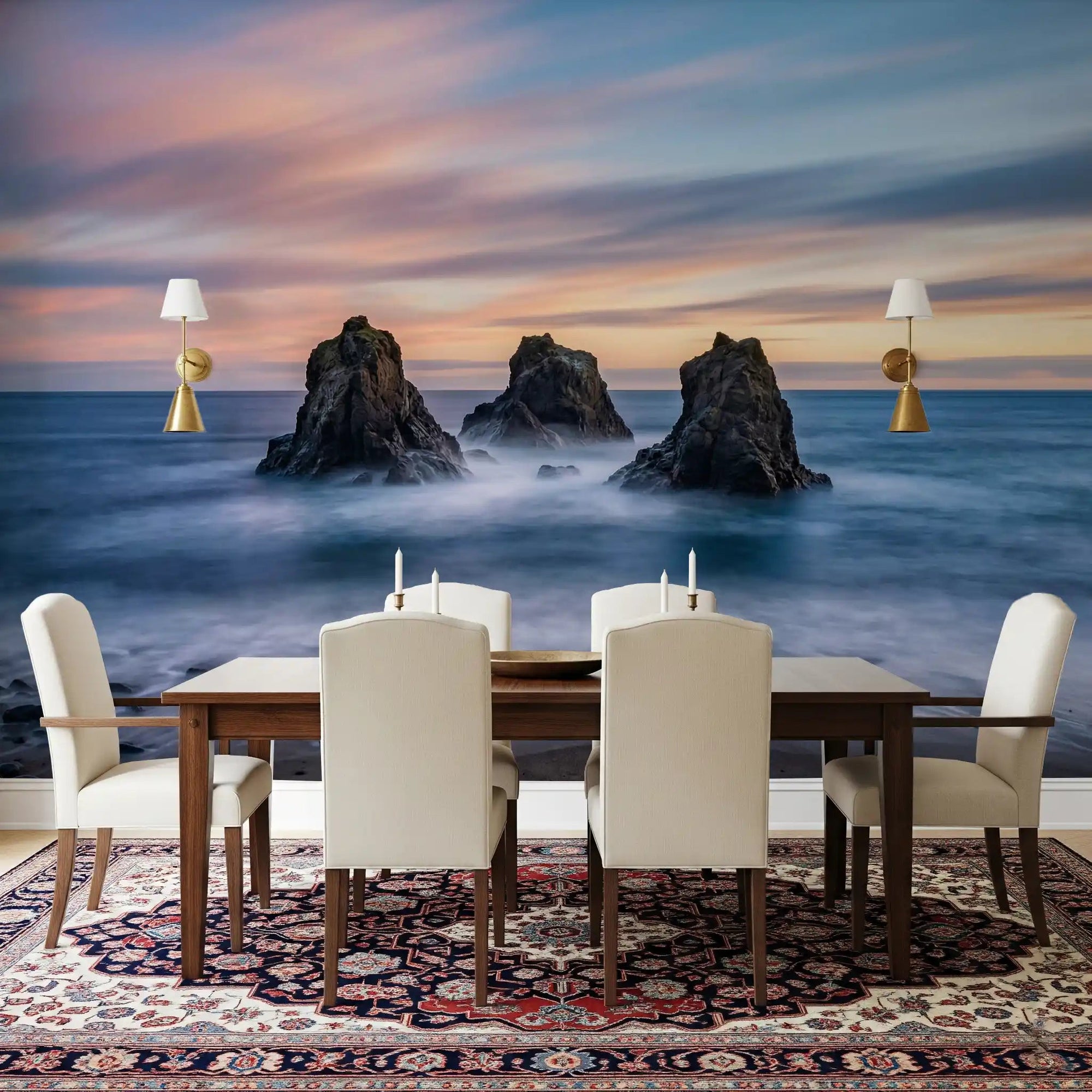 Behind the dining table, pastel sunset skies stretch through this Ocean Rocks wall mural, GD9064