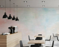 Misty pastel hues of the Ethereal Watercolor Wash Wall Mural grace a modern cafe setting.