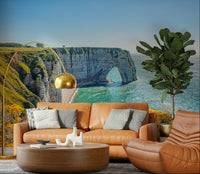 Etretat's Yellow Bloom Wall Mural gives this lounge a bright cliffside coastal backdrop