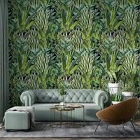 The image features large, lush leaves and other plant life.
