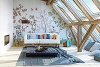 Birds are shown flying away from a cluster of flowers.

