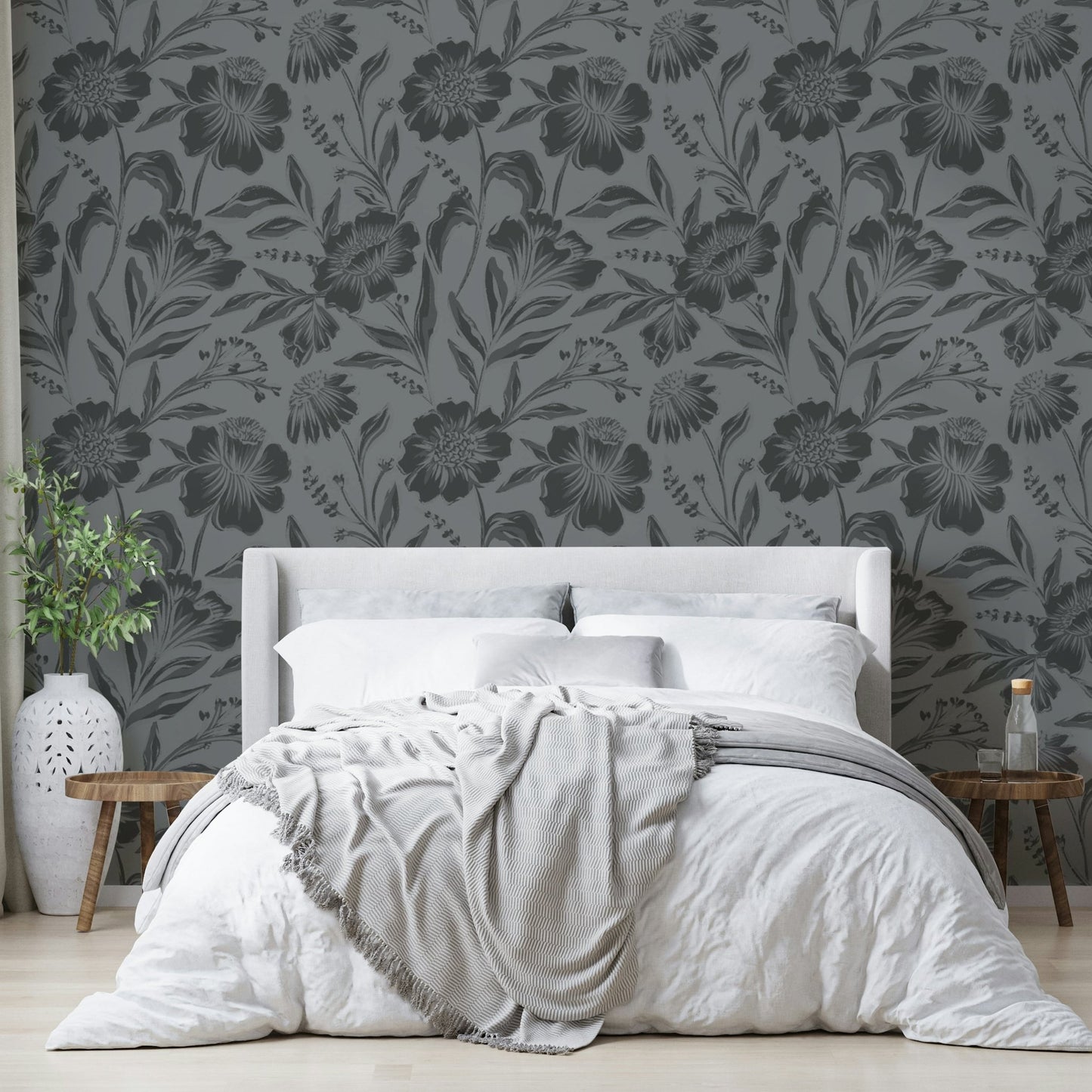 The image features large flowers and leaves depicted as soft silhouettes.
