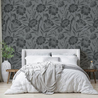 The image features large flowers and leaves depicted as soft silhouettes.
