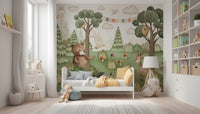 Forest Friends Mural wallpaper behind a wooden crib in a nursery.