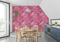 Botanical print wallpaper with pale blooms across a strong fuchsia ground