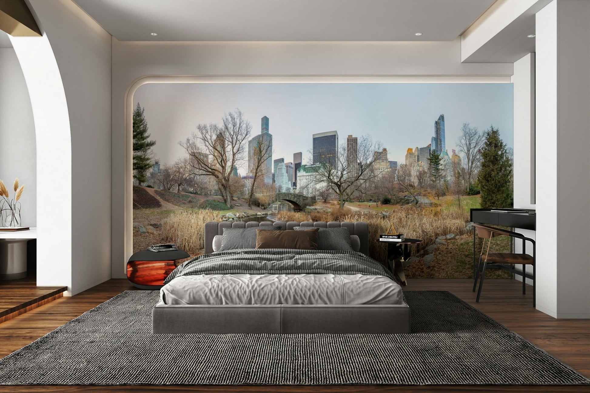 The bridge is made of stone and is arched over a calm body of water.

