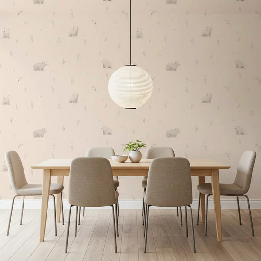 Soft bear motifs run behind a calm dining table in Gentle Bear Meadow wallpaper