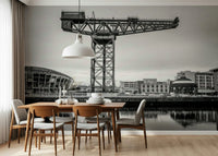 Industrial city landscape mural in a modern living room with grey furniture.