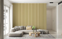 Soft gold vertical lines frame a low neutral sofa with Golden Grid Stripes Wallpaper
