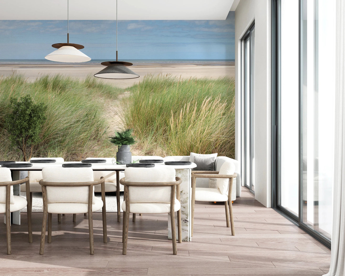 A bright dining area opens onto Grassland by the Sea Wall Mural and dune grass views