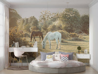 The horses are in a sunlit field with green grass.

