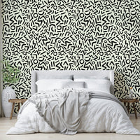 Hand drawn abstract tribal wallpaper on a living room wall

