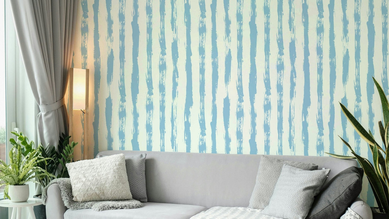 Hand drawn sky blue stripes wallpaper on a wall

