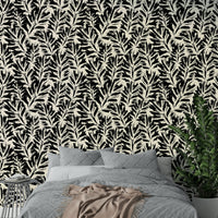 A living room decorated with a painted leaf mural

