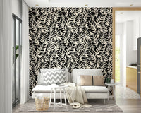Hand painted leaves wallpaper on a bedroom wall

