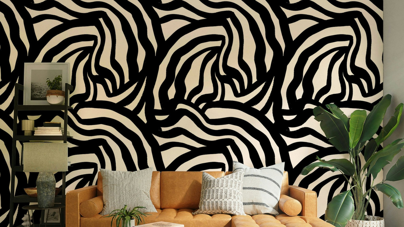 A full wall decorated with the wavy black lines wallpaper, styled in a minimalist room