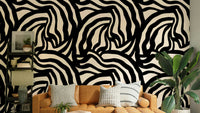 A full wall decorated with the wavy black lines wallpaper, styled in a minimalist room