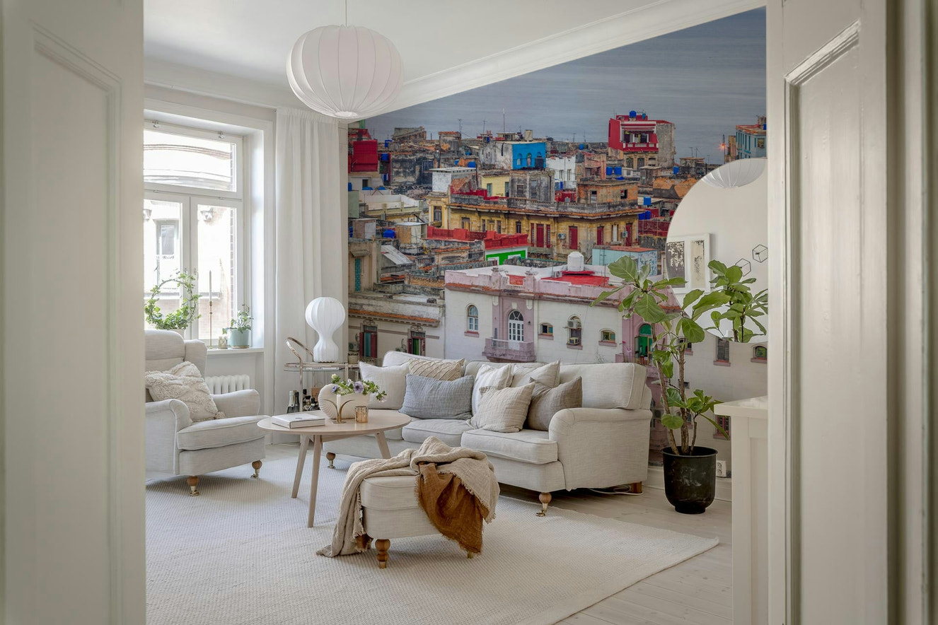 Havana Skyline Charm Wall Mural behind a comfortable seating area.