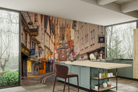 Evening town wall mural with glowing windows and rooftops.

