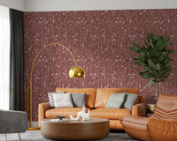 Lounge corner with Homeland Floral Terracotta Wallpaper and warm rust seating