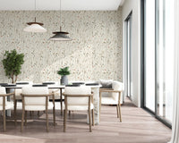 Daylight keeps this dining space airy against the quiet pattern of Homeland Floral Winter Wallpaper