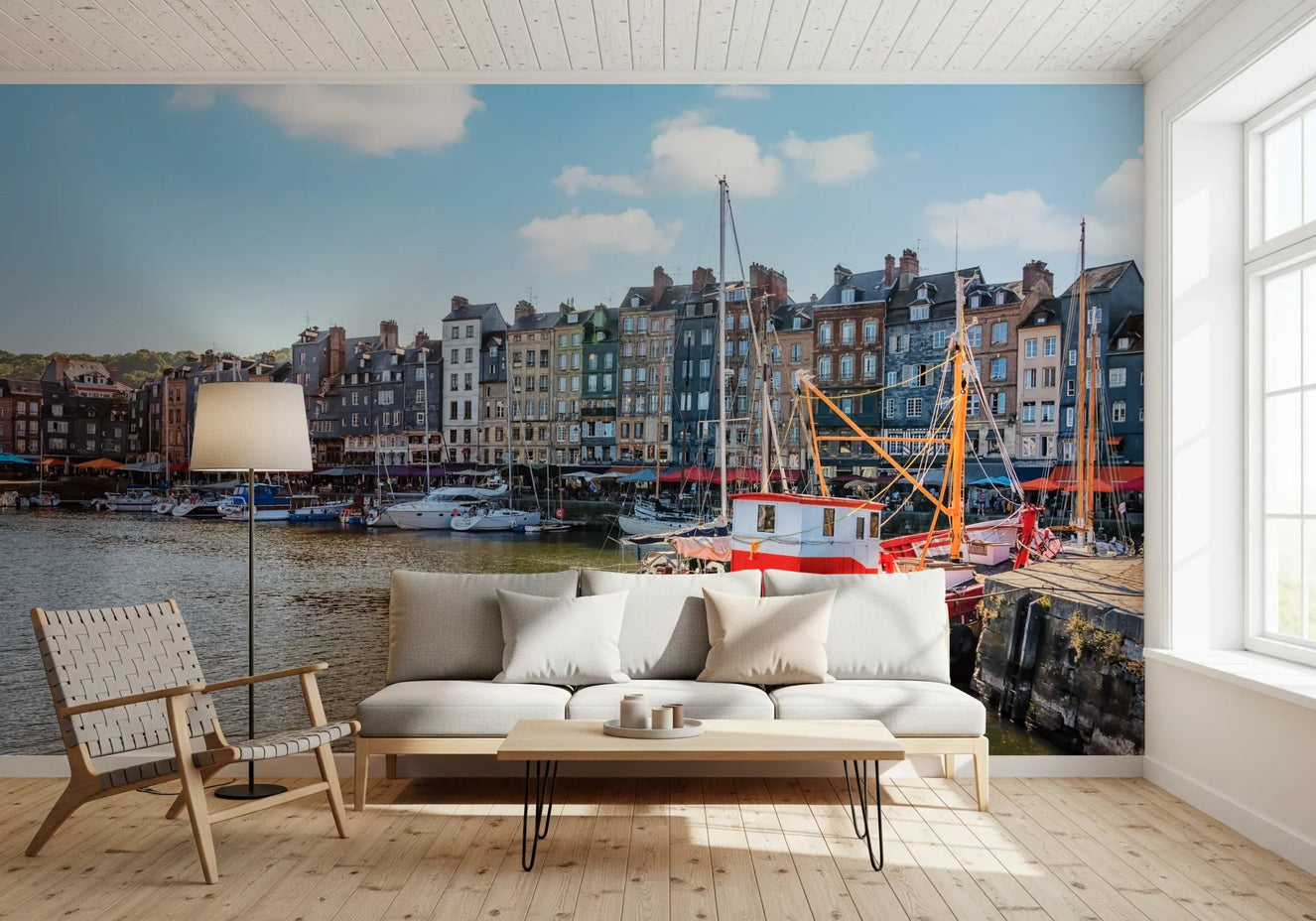 Living room with Honfleur Harbor Charm wall mural and colorful waterfront boats