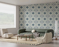 Indigo Bloom Tiles Wallpaper behind a green sofa in a calm living room