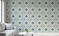 Indigo Bloom Tiles Wallpaper in a light lounge with a gray sofa and round table