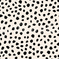 A seamless pattern of irregular black spots on a wall

