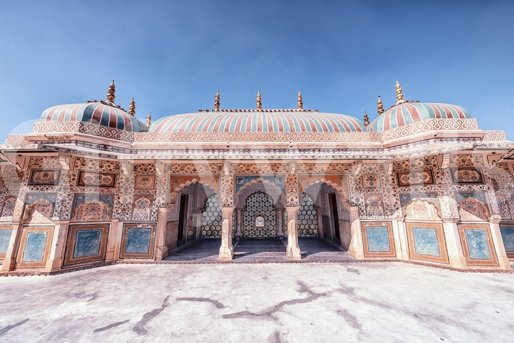 Jaipur Jewel wall mural with painted palace facade, domes, and open blue sky above
