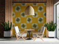 A graceful subtle bloom wall mural in warm, mustard tones.