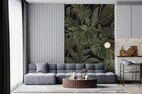 Monstera wall mural with oversized jungle leaves on dark ground