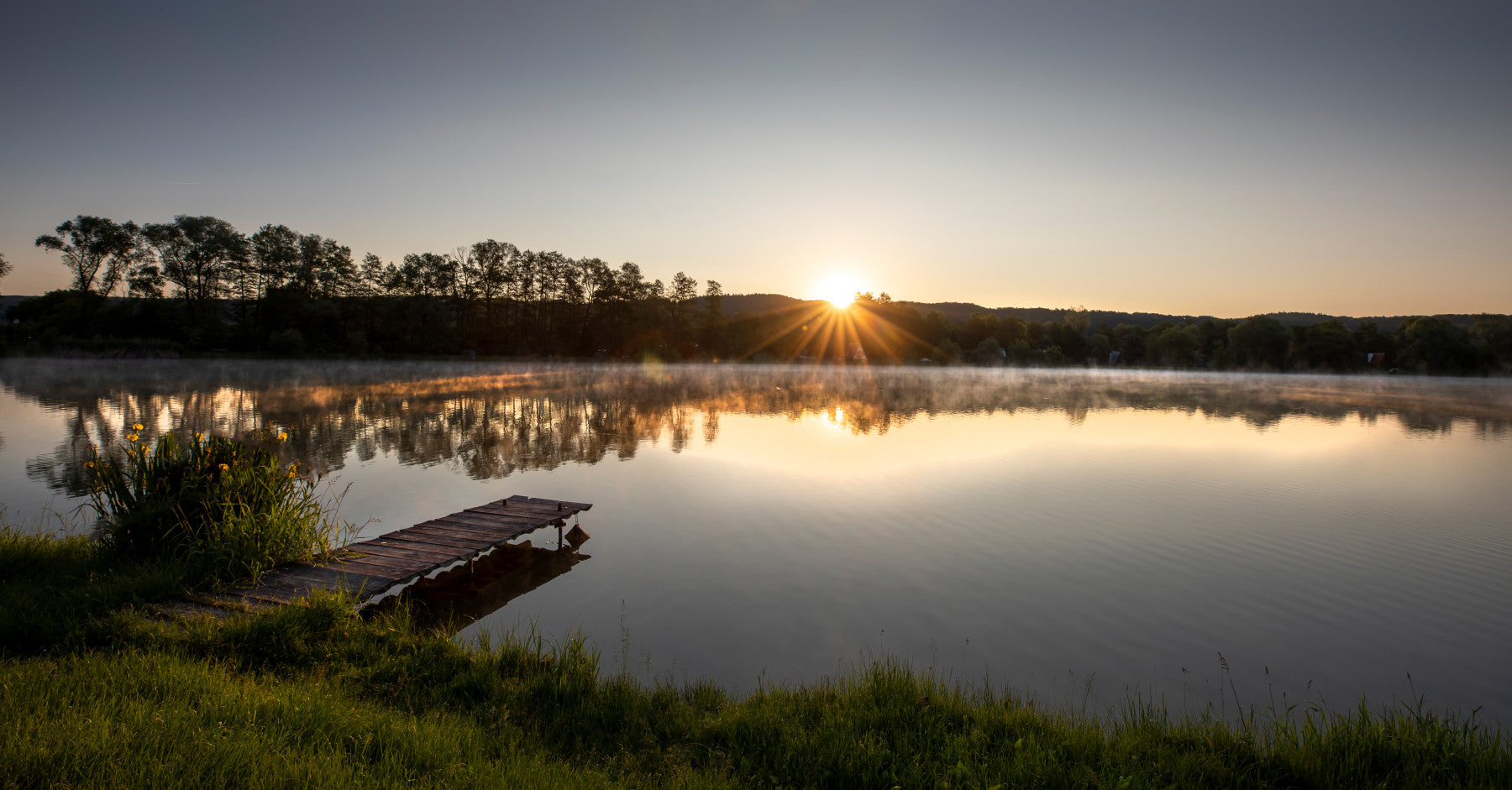Tranquil Sunrise Reflection Over Serene Lake Wall Mural