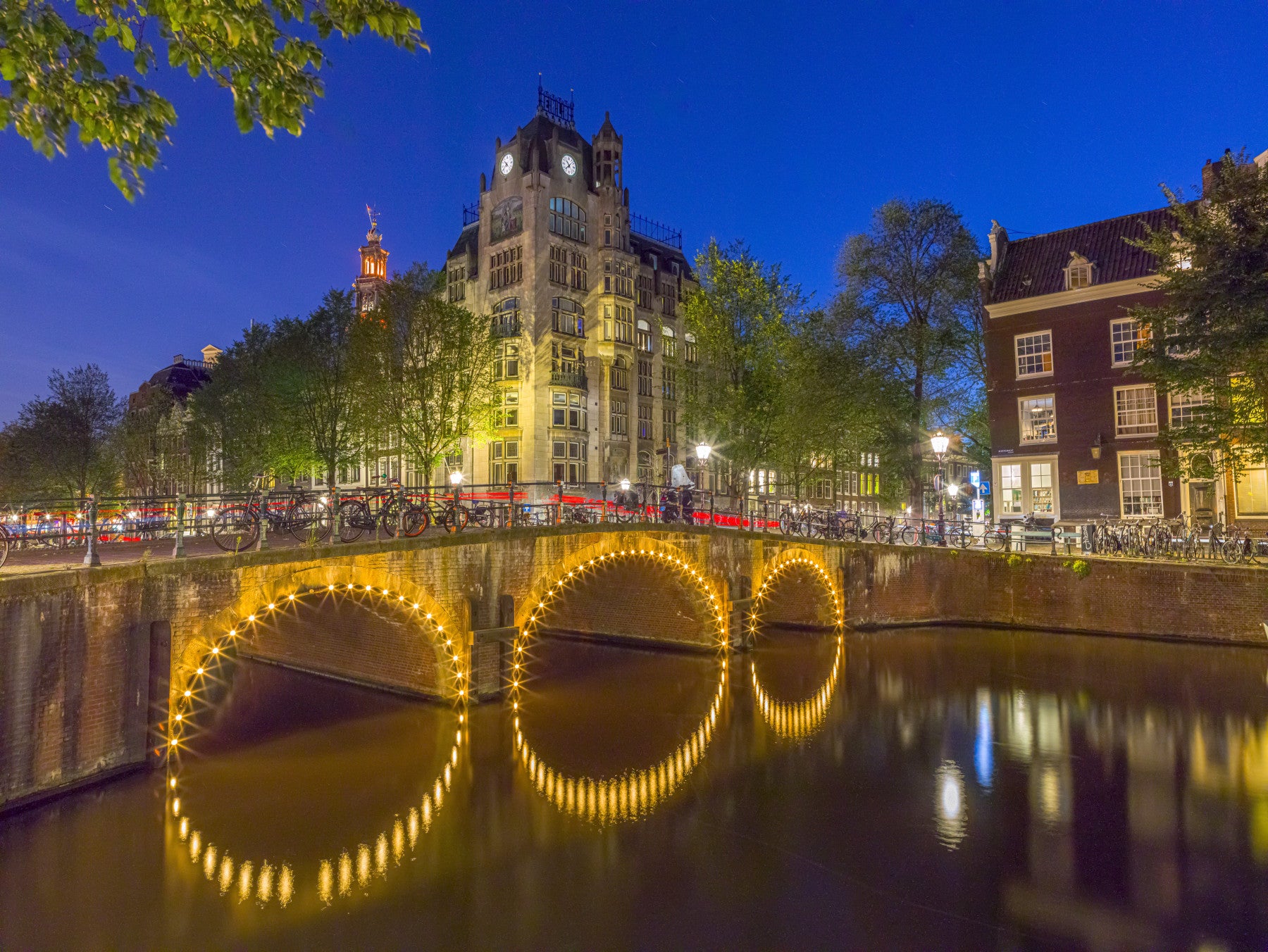 Canal through Amsterdam city Wall Mural