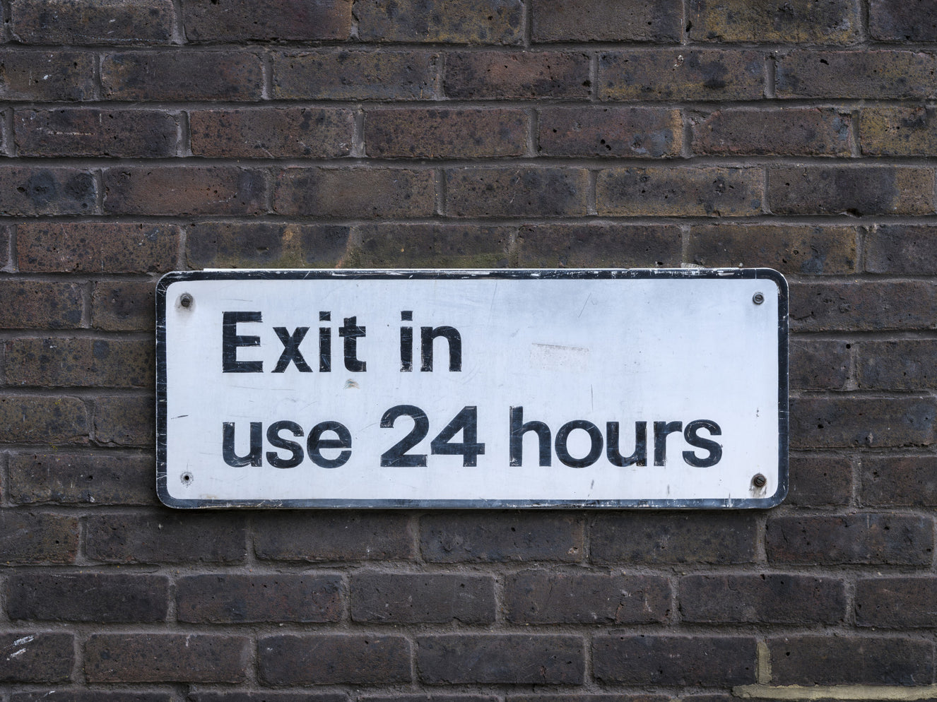 Weathered Exit on Textured Brick Wall Mural