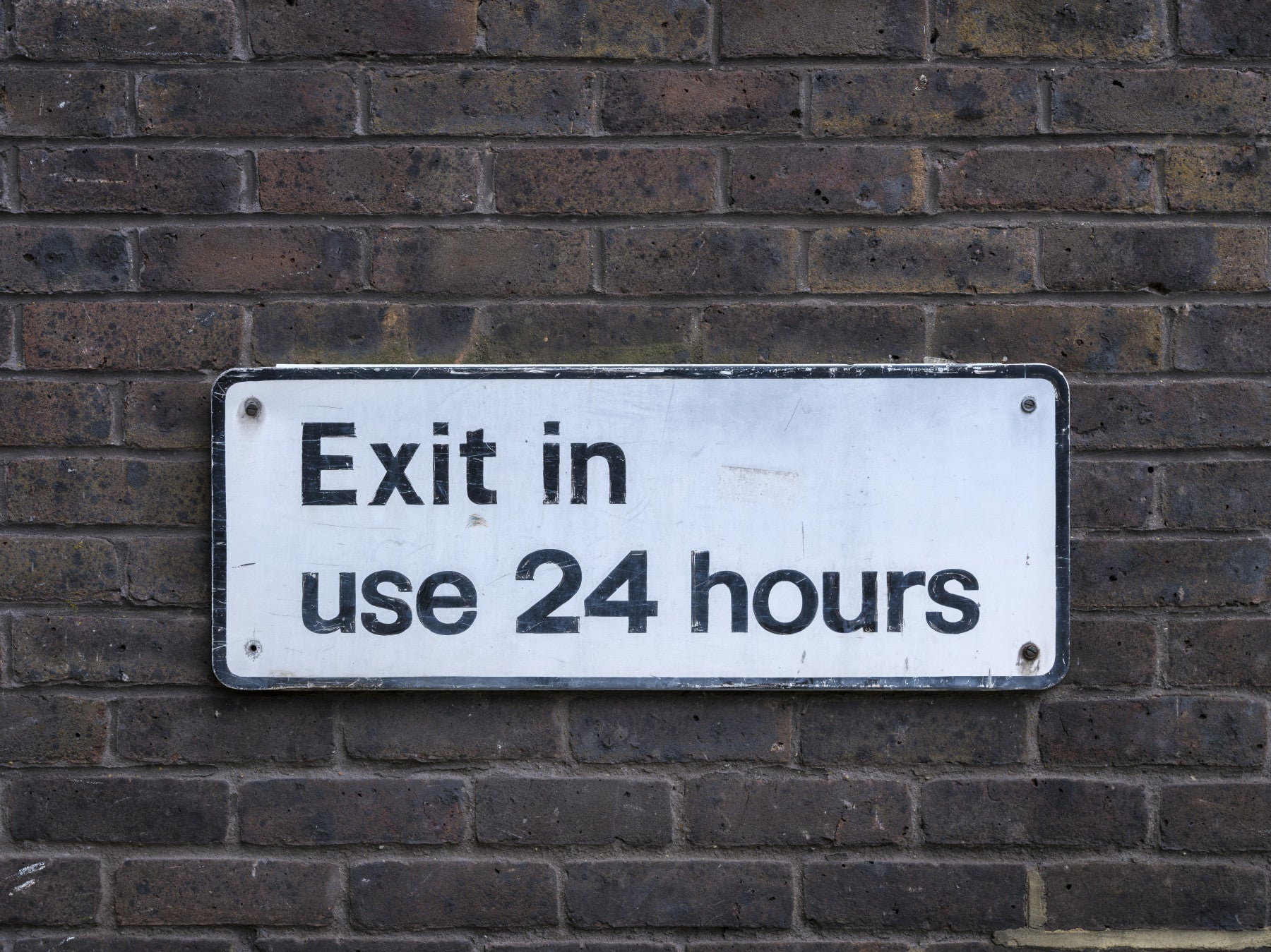 Weathered Exit on Textured Brick Wall Mural
