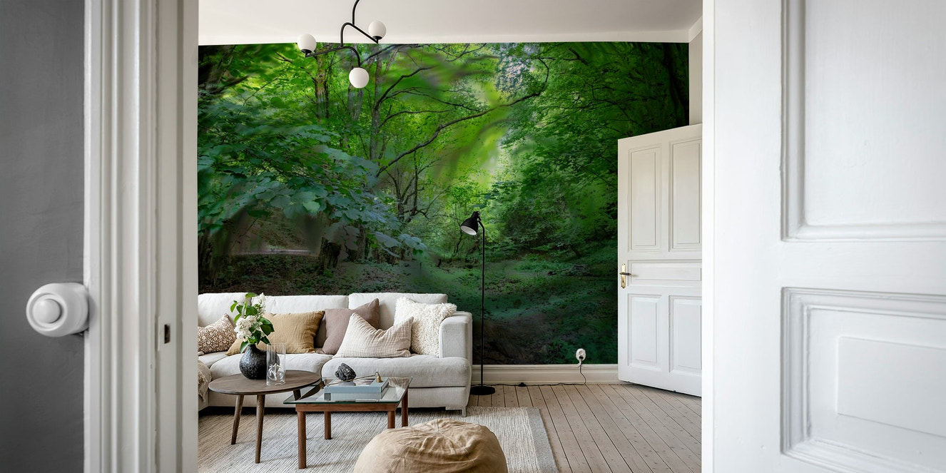 A wall mural of a lush green forest with a pathway.

